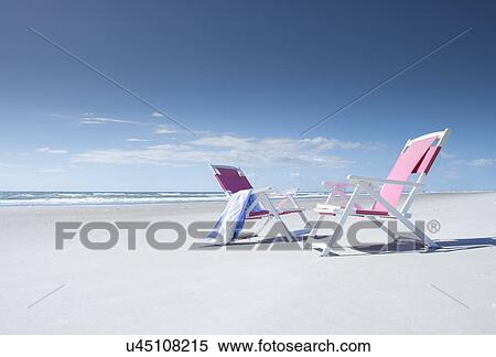 Two deckchairs on empty beach View Large Photo Image Stock Photography - Two deckchairs on empty beach. Fotosearch