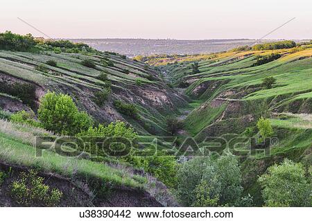 Ukraine, Dnepropetrovsk region, Dnepropetrovsk city, Green landscape formed by geological erosion View Large Photo Image Stock Image - Ukraine, Dnepropetrovsk region, Dnepropetrovsk city, Green landscape formed by geological erosion. Fotosearch