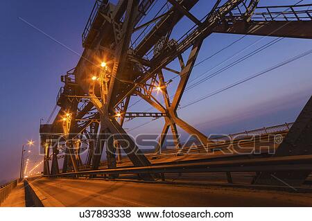 Stock Photo - Ukraine, Dnepropetrovsk region, Dnepropetrovsk city, Illuminated bridge at dusk. Fotosearch