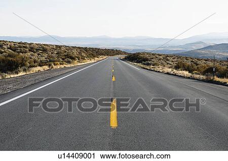 Stock Image - USA, California, Eastern Sierras, Route 88, Sky over empty road. Fotosearch