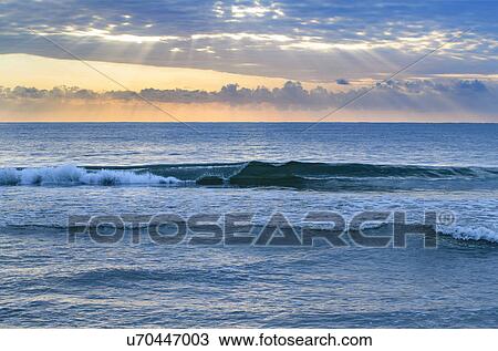 Stock Image - USA, Florida, Ocean waves at sunset. Fotosearch