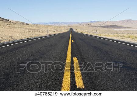 Stock Photo - USA, Nevada, Highway 50, Clear sky over empty road. Fotosearch