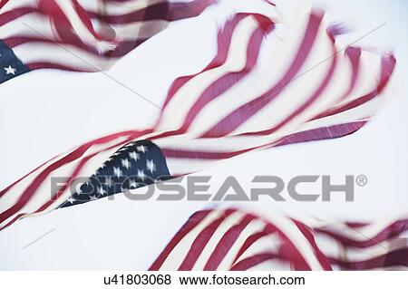 Stock Photo - American flag flying in wind. Fotosearch