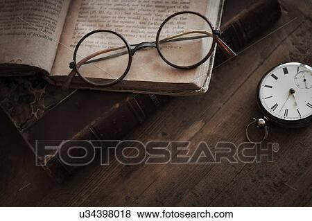 Stock Photo - Antique book, watch and eyeglasses. Fotosearch