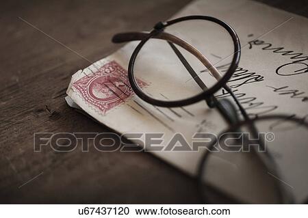 Stock Image - Antique eyeglasses with envelope. Fotosearch