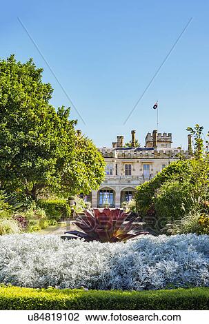 Stock Image - Australia, New South Wales, Sydney, Ornamental garden with building in background. Fotosearch