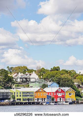 Stock Photograph - Australia, New South Wales, Sydney, Colorful houses near water. Fotosearch