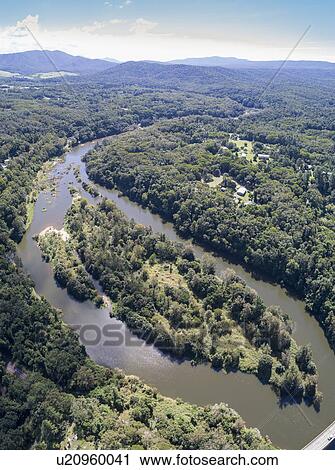 Stock Image - Australia, Queensland, Landscape with river and rainforest. Fotosearch