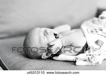 Baby boy (0-1 months) lying on back and yawning View Large Photo Image Stock Image - Baby boy (0-1 months) lying on back and yawning. Fotosearch