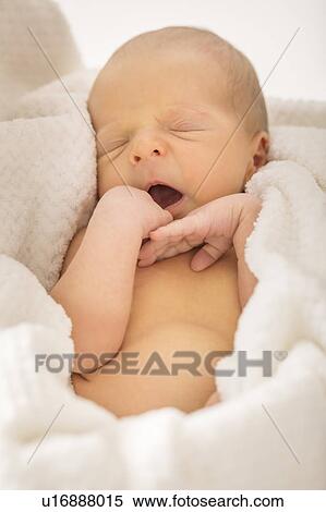 Stock Photography - Baby boy (0-1 months) yawning. Fotosearch