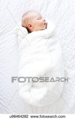 Baby boy (2-5 months) sleeping in white blanket View Large Photo Image Stock Image - Baby boy (2-5 months) sleeping in white blanket. Fotosearch