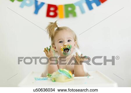 Baby girl (12-17 months) celebrating first birthday View Large Photo Image Picture - Baby girl (12-17 months) celebrating first birthday. Fotosearch
