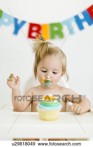 Baby girl (12-17 months) celebrating first birthday View Large Photo Image Stock Photo - Baby girl (12-17 months) celebrating first birthday. Fotosearch