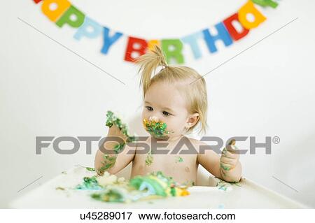 Baby girl (12-17 months) celebrating first birthday View Large Photo Image Stock Photo - Baby girl (12-17 months) celebrating first birthday. Fotosearch