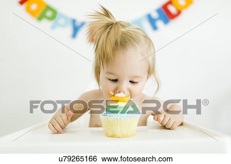Baby girl (12-17 months) celebrating first birthday View Large Photo Image Stock Photograph - Baby girl (12-17 months) celebrating first birthday. Fotosearch