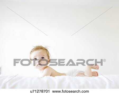 Baby girl (6-11 months) playing in bedroom View Large Photo Image Stock Image - Baby girl (6-11 months) playing in bedroom. Fotosearch