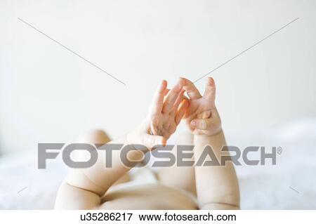 Baby girl (6-11 months) playing in bedroom View Large Photo Image Stock Photo - Baby girl (6-11 months) playing in bedroom. Fotosearch