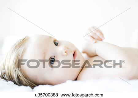 Baby girl (6-11 months) playing in bedroom View Large Photo Image Stock Photo - Baby girl (6-11 months) playing in bedroom. Fotosearch