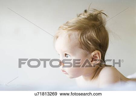 Stock Photo - Baby girl (6-11 months) playing in bedroom. Fotosearch