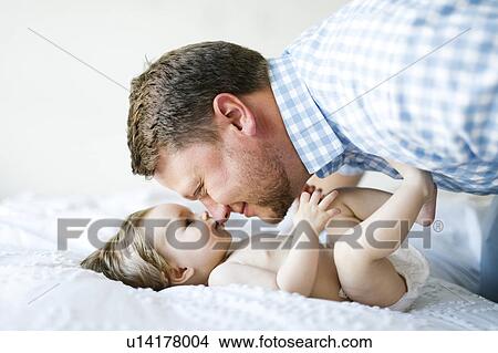 Baby girl (6-11 Months) with father face to face View Large Photo Image Picture - Baby girl (6-11 Months) with father face to face. Fotosearch