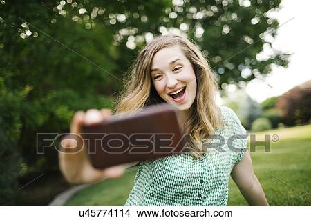 Beautiful woman taking selfie View Large Photo Image Picture - Beautiful woman taking selfie. Fotosearch