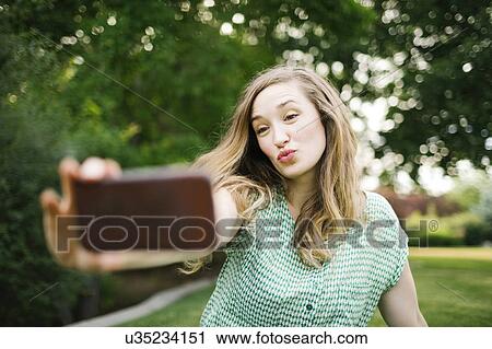 Beautiful woman taking selfie View Large Photo Image Stock Image - Beautiful woman taking selfie. Fotosearch