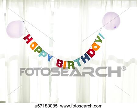 Birthday garland hanging in front of net curtain View Large Photo Image Stock Photography - Birthday garland hanging in front of net curtain. Fotosearch