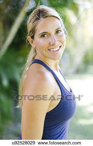 Blonde woman in tank top smiling View Large Photo Image Stock Photo - Blonde woman in tank top smiling. Fotosearch