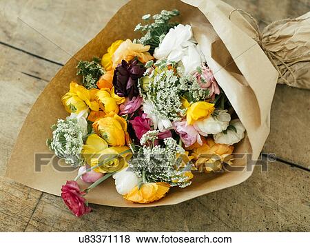 Bouquet wrapped in paper View Large Photo Image Stock Photo - Bouquet wrapped in paper. Fotosearch