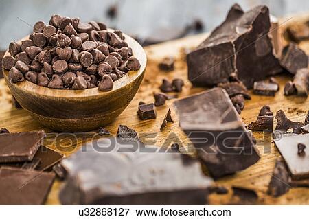 Bowl of chocolate chips and various chocolate pieces on cutting board View Large Photo Image Stock Photo - Bowl of chocolate chips and various chocolate pieces on cutting board. Fotosearch