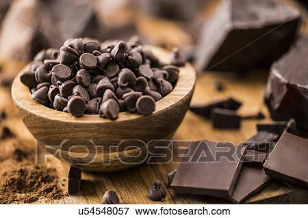 Bowl of chocolate chips and various chocolate pieces on cutting board View Large Photo Image Stock Photo - Bowl of chocolate chips and various chocolate pieces on cutting board. Fotosearch