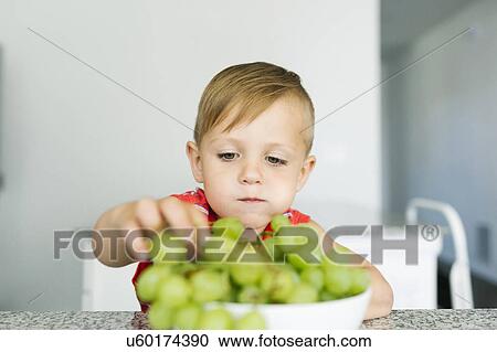 Boy (2-3) eating white grapes in kitchen View Large Photo Image Stock Image - Boy (2-3) eating white grapes in kitchen. Fotosearch