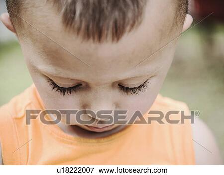 Stock Photo - Boy (2-3) looking down. Fotosearch