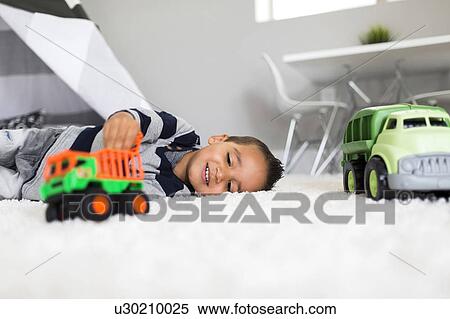 Stock Photography - Boy (2-3) playing with toys in room. Fotosearch