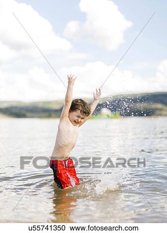 Boy (4-5) jumping in lake View Large Photo Image Stock Image - Boy (4-5) jumping in lake. Fotosearch