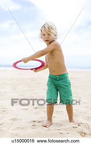 Boy (4-5) playing with plastic ring View Large Photo Image Stock Photograph - Boy (4-5) playing with plastic ring. Fotosearch