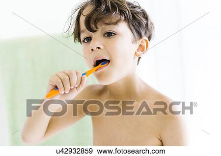 Boy (6-7) brushing teeth View Large Photo Image Stock Photo - Boy (6-7) brushing teeth. Fotosearch