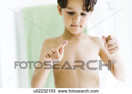 Boy (6-7) flossing teeth View Large Photo Image Stock Image - Boy (6-7) flossing teeth. Fotosearch