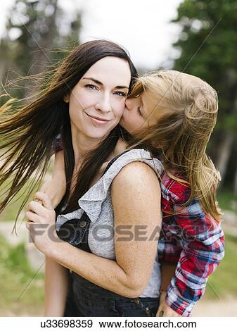Boy (6-7) kissing his mother View Large Photo Image Stock Photo - Boy (6-7) kissing his mother. Fotosearch