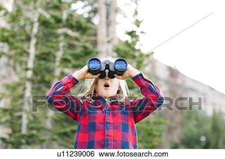 Boy (6-7) using binoculars in forest View Large Photo Image Stock Photograph - Boy (6-7) using binoculars in forest. Fotosearch