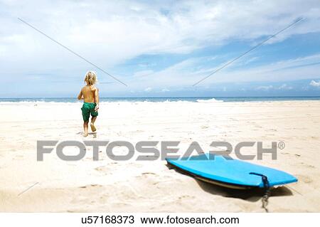Boy running on beach View Large Photo Image Stock Image - Boy running on beach. Fotosearch