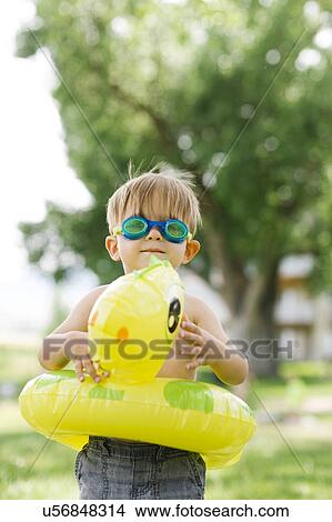 Boy(2-3) with inflatable ring-turtle View Large Photo Image Picture - Boy(2-3) with inflatable ring-turtle. Fotosearch