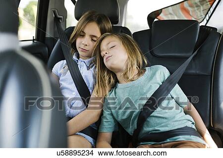 Brother (6-7) and sister ( 8-9) sleeping in car View Large Photo Image Picture - Brother (6-7) and sister ( 8-9) sleeping in car. Fotosearch