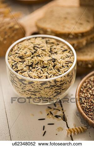 Stock Image - Brown and black rice in bowl. Fotosearch
