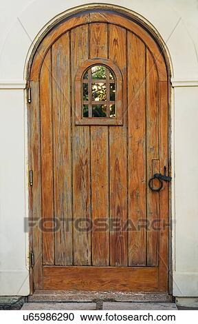 Stock Image - Building exterior with wooden door. Fotosearch