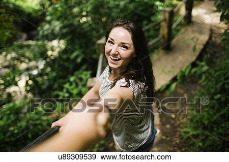 Caribbean Islands, Saint Lucia, Smiling women standing on path, holding person's hand and looking at camera View Large Photo Image Stock Photo - Caribbean Islands, Saint Lucia, Smiling women standing on path, holding person's hand and looking at camera. Fotosearch