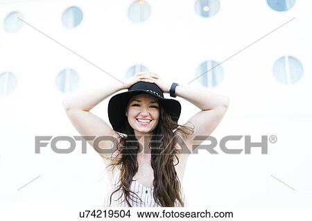 Picture - Cheerful woman in black hat. Fotosearch