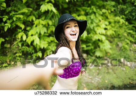 Cheerful woman taking selfie in forest View Large Photo Image Stock Image - Cheerful woman taking selfie in forest. Fotosearch