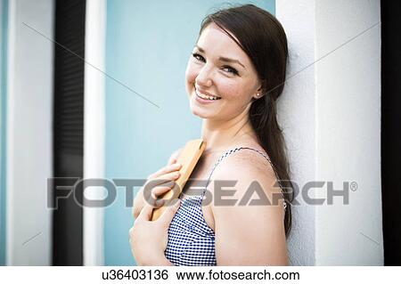 Cheerful woman with digital tablet leaning against building wall View Large Photo Image Stock Photograph - Cheerful woman with digital tablet leaning against building wall. Fotosearch