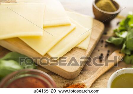 Cheese on cutting board View Large Photo Image Stock Image - Cheese on cutting board. Fotosearch